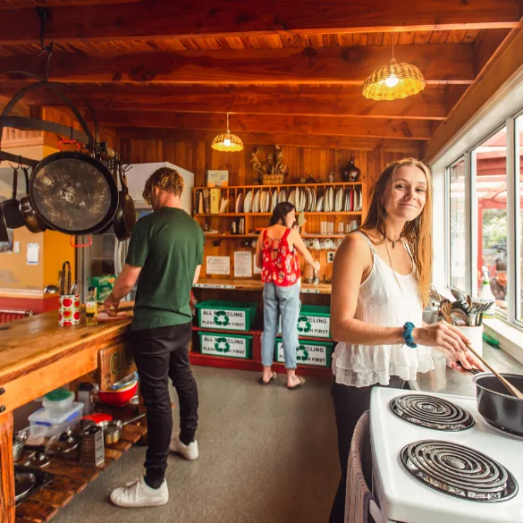 Three people preparing food in a cabin